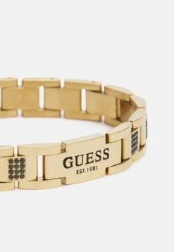 Guess FLAT CHAIN UNISEX - Bracelet - Yellow Gold-coloured/black -Guess Clothing Sale fd311288d4ce4d2496583ebaa75a1e4a